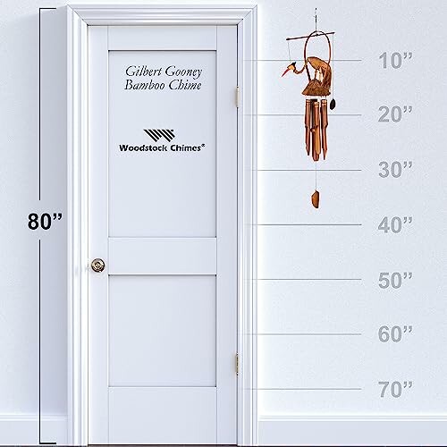 Bamboo wind chime hanging beside a door with height measurements.