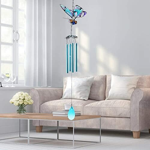 Living room with a butterfly wind chime and modern decor.