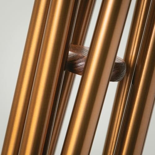 Close-up of vertical metallic rods with a wooden element