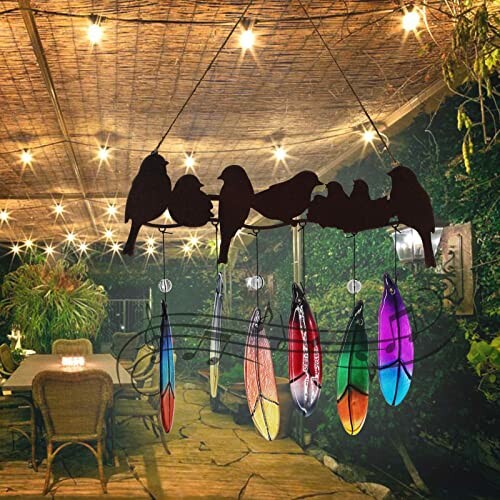 Outdoor patio with feather wind chime and string lights.