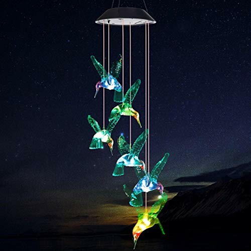 A Colorful solar-powered hummingbird wind chime at night