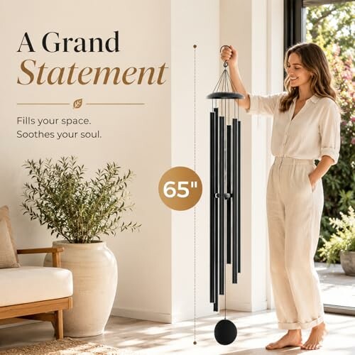Woman holding a large 65-inch wind chime indoors.