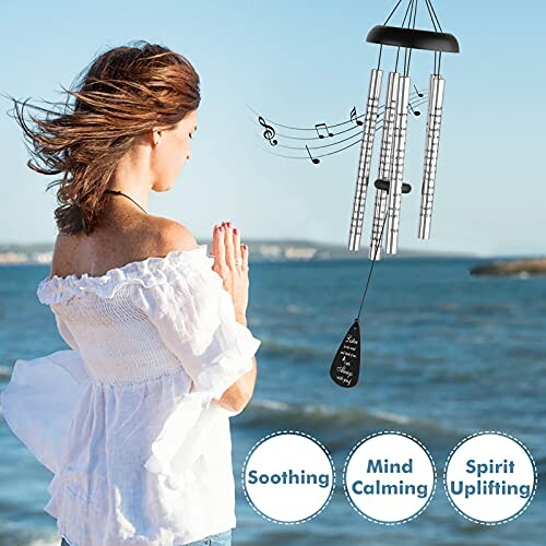 Woman by the sea with wind chimes and musical notes.